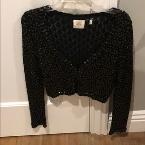 Anthro cropped black sweater with sequin detail.
